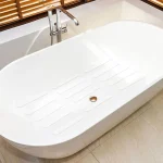 Clear anti-slip strips inside a white bathtub for shower safety